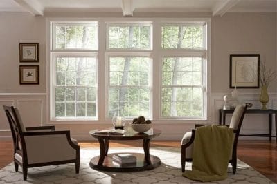 Living room with large custom insulated glass windows for natural light and energy efficiency.