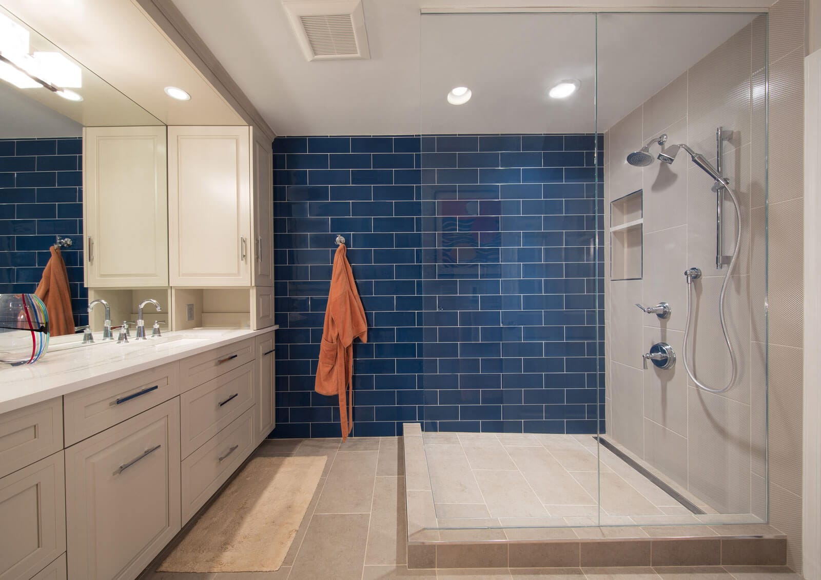 Bathroom with a glass panels and a navy blue tiled accent wall